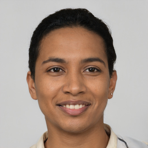 Joyful latino young-adult male with short  black hair and brown eyes