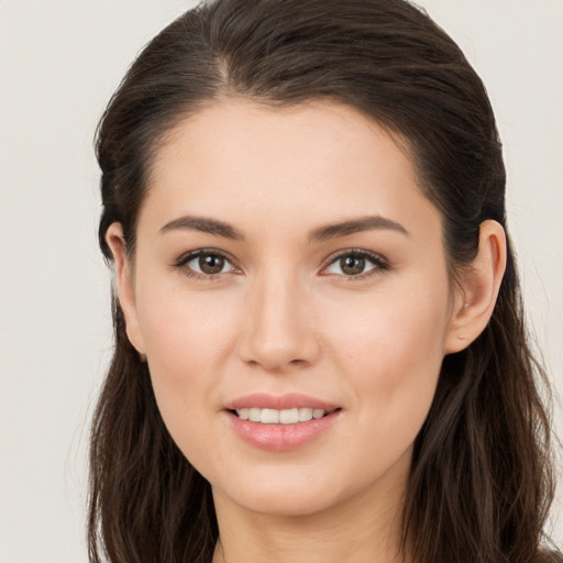 Joyful white young-adult female with long  brown hair and brown eyes