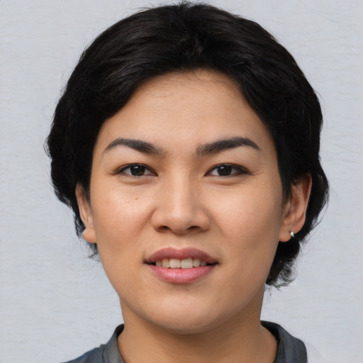 Joyful asian young-adult female with medium  black hair and brown eyes