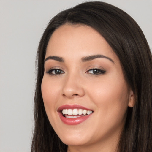 Joyful white young-adult female with long  black hair and brown eyes