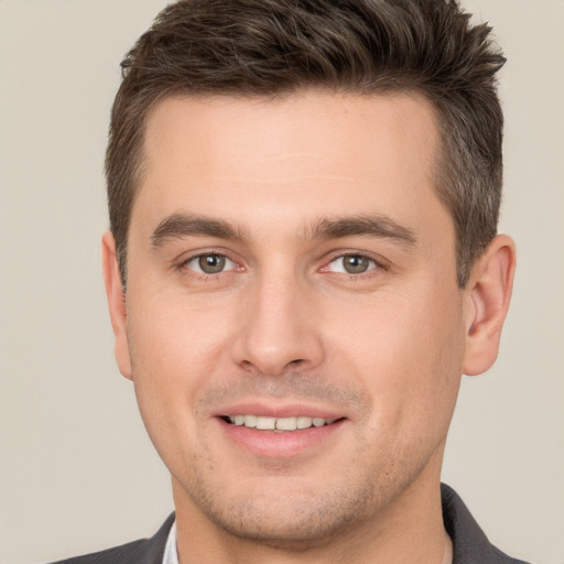 Joyful white young-adult male with short  brown hair and brown eyes