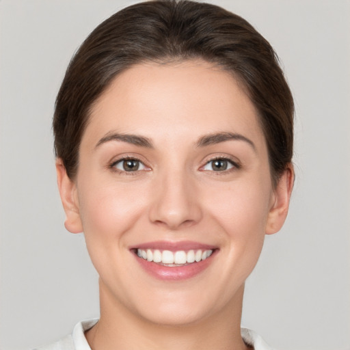 Joyful white young-adult female with short  brown hair and brown eyes