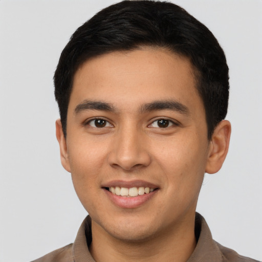 Joyful latino young-adult male with short  brown hair and brown eyes