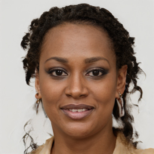 Joyful black young-adult female with medium  brown hair and brown eyes