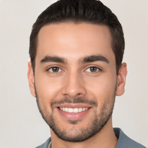 Joyful white young-adult male with short  brown hair and brown eyes