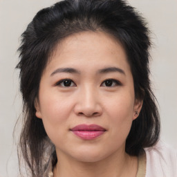 Joyful asian young-adult female with medium  brown hair and brown eyes