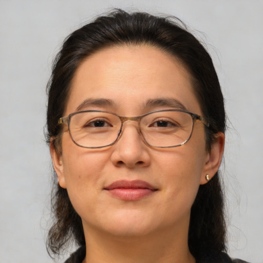 Joyful white adult female with medium  brown hair and brown eyes