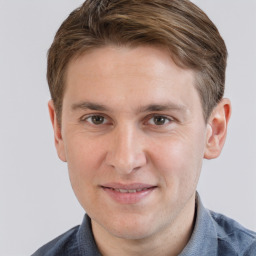 Joyful white young-adult male with short  brown hair and grey eyes