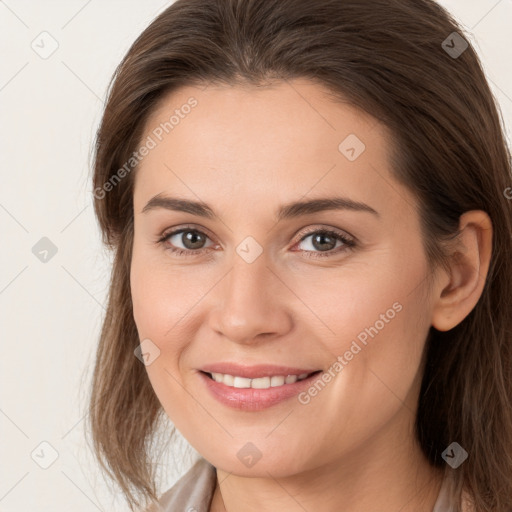 Joyful white young-adult female with long  brown hair and brown eyes