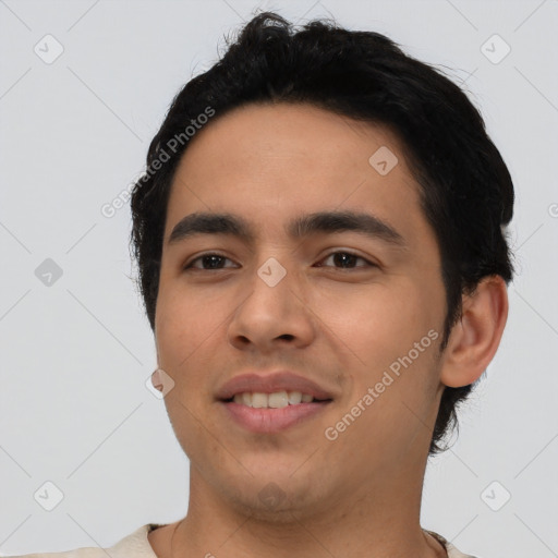 Joyful latino young-adult male with short  black hair and brown eyes