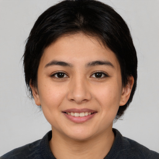 Joyful white young-adult female with medium  black hair and brown eyes