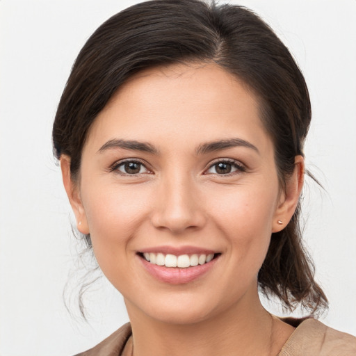 Joyful white young-adult female with medium  brown hair and brown eyes