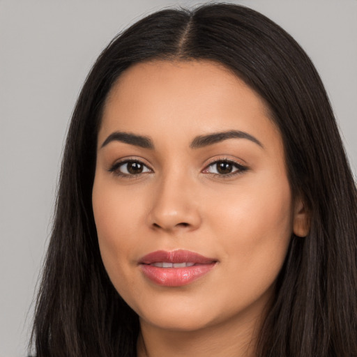 Joyful latino young-adult female with long  black hair and brown eyes