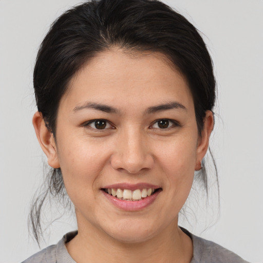 Joyful asian young-adult female with medium  brown hair and brown eyes