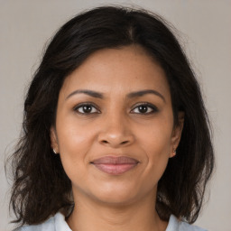 Joyful black young-adult female with medium  brown hair and brown eyes