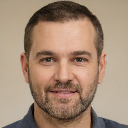 Joyful white adult male with short  brown hair and brown eyes