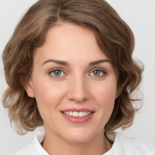 Joyful white young-adult female with medium  brown hair and green eyes