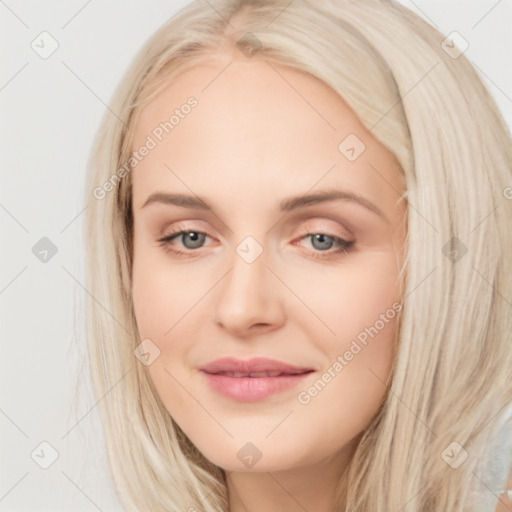 Joyful white young-adult female with long  brown hair and blue eyes