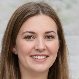 Joyful white young-adult female with long  brown hair and green eyes