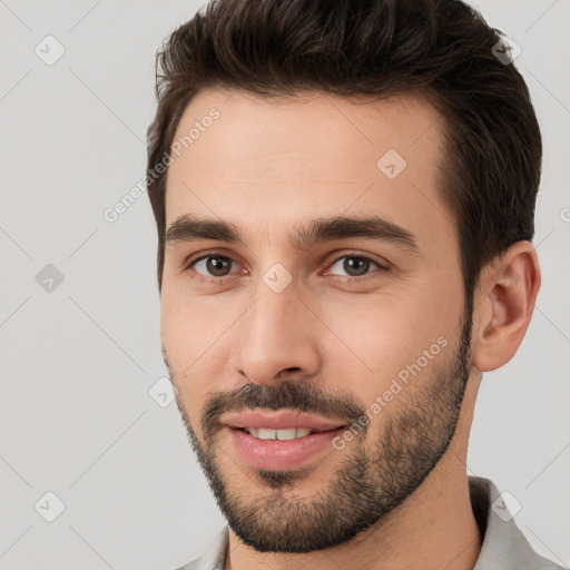 Joyful white young-adult male with short  brown hair and brown eyes