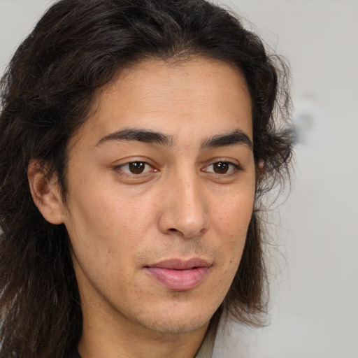 Neutral white young-adult male with long  brown hair and brown eyes