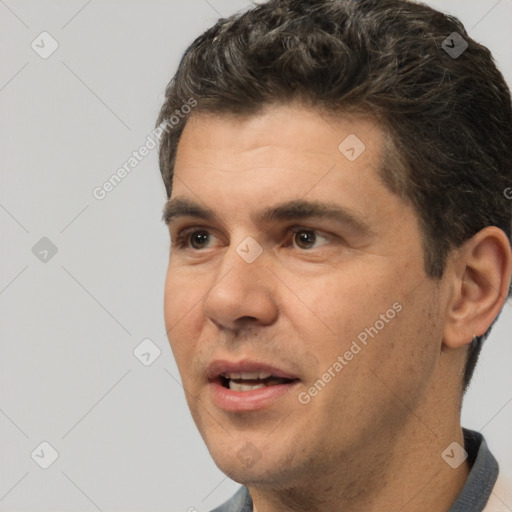 Joyful white adult male with short  brown hair and brown eyes