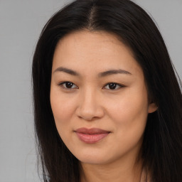 Joyful asian young-adult female with long  brown hair and brown eyes