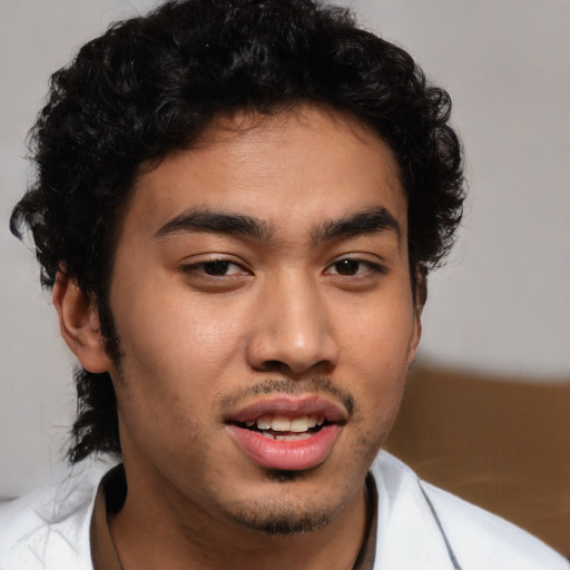 Joyful latino young-adult male with short  brown hair and brown eyes