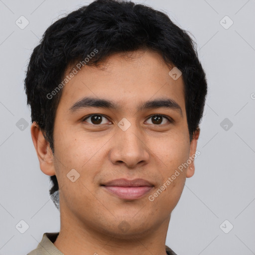 Joyful latino young-adult male with short  brown hair and brown eyes