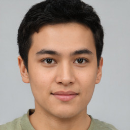 Joyful asian young-adult male with short  brown hair and brown eyes