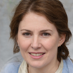 Joyful white young-adult female with medium  brown hair and blue eyes