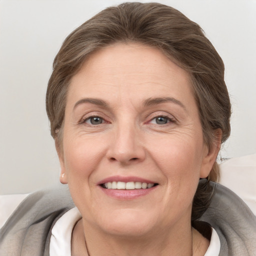 Joyful white adult female with short  brown hair and grey eyes