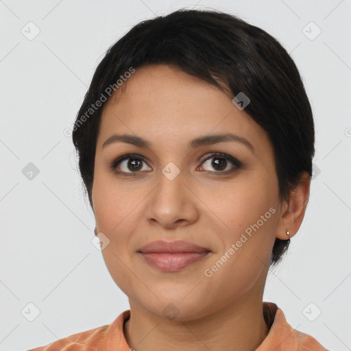 Joyful latino young-adult female with short  black hair and brown eyes