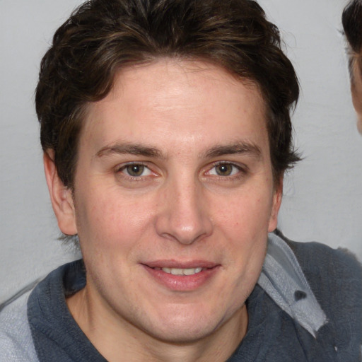 Joyful white adult male with medium  brown hair and blue eyes