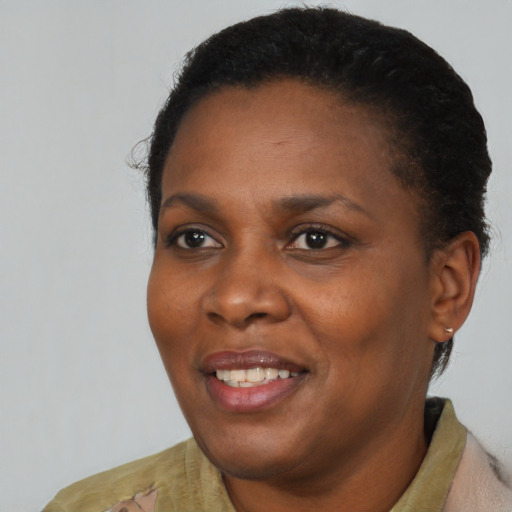 Joyful black young-adult female with short  black hair and brown eyes