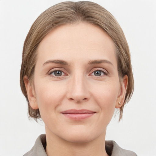 Joyful white young-adult female with medium  brown hair and grey eyes