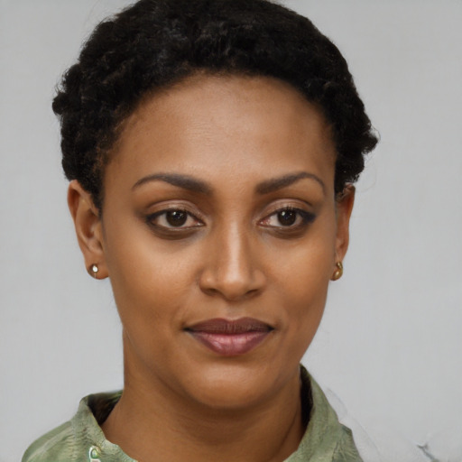 Joyful black young-adult female with short  brown hair and brown eyes