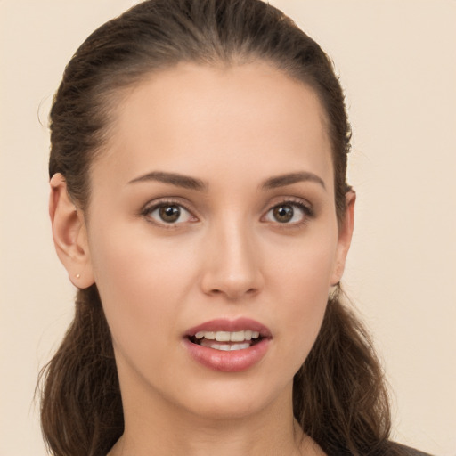 Joyful white young-adult female with long  brown hair and brown eyes