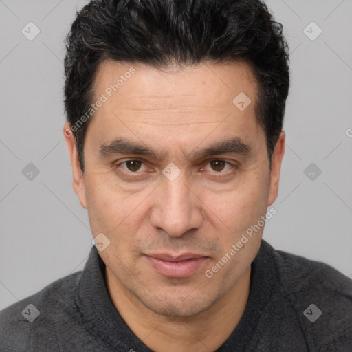 Joyful white adult male with short  black hair and brown eyes