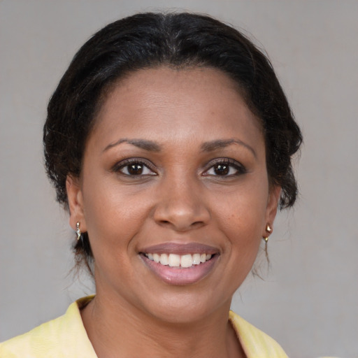 Joyful black young-adult female with medium  brown hair and brown eyes