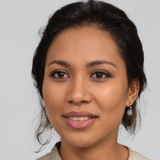 Joyful latino young-adult female with medium  brown hair and brown eyes