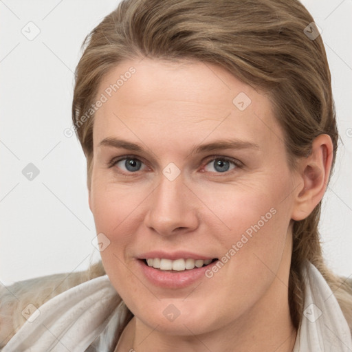 Joyful white young-adult female with long  brown hair and blue eyes