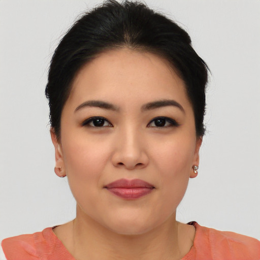 Joyful asian young-adult female with short  black hair and brown eyes