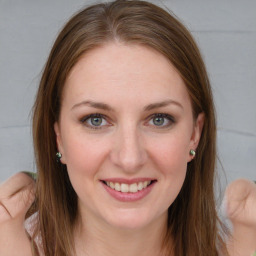 Joyful white young-adult female with long  brown hair and blue eyes