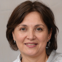 Joyful white adult female with medium  brown hair and brown eyes