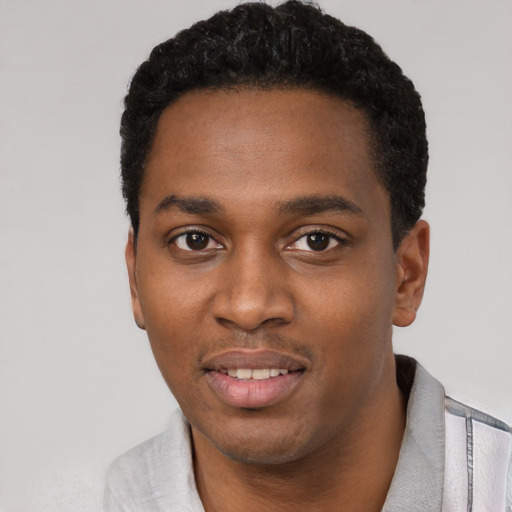 Joyful black young-adult male with short  black hair and brown eyes