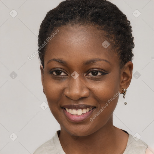 Joyful black young-adult female with short  black hair and brown eyes