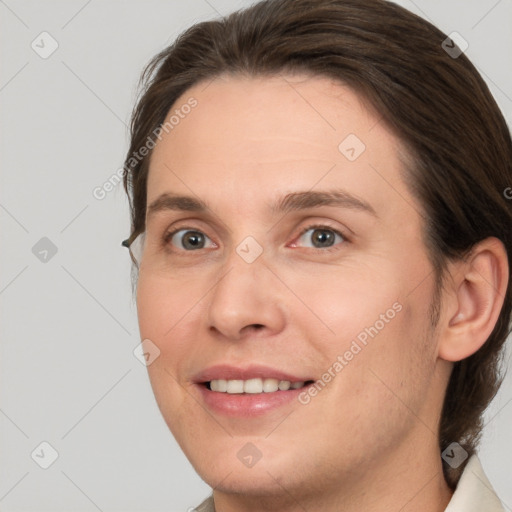 Joyful white adult female with medium  brown hair and brown eyes