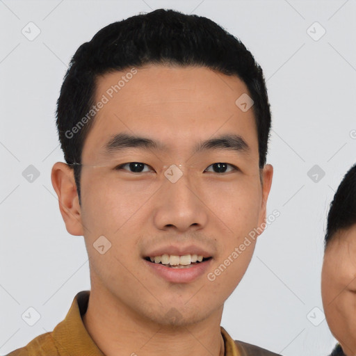 Joyful asian young-adult male with short  black hair and brown eyes