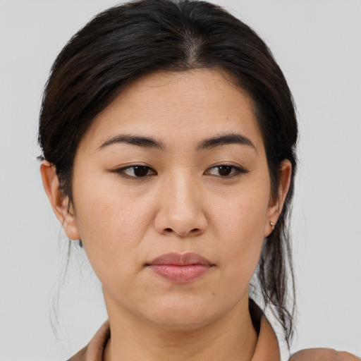 Joyful asian young-adult female with medium  brown hair and brown eyes